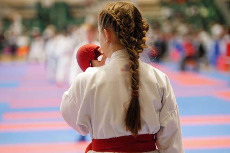 girl wearing custom mouthguard while competing in a karate tournament
