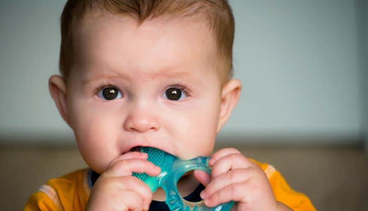 baby chewing on teething ring